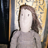 Primitive Doll Holding A Piece Of Fabric That Has ABC,123 Stocked In To It