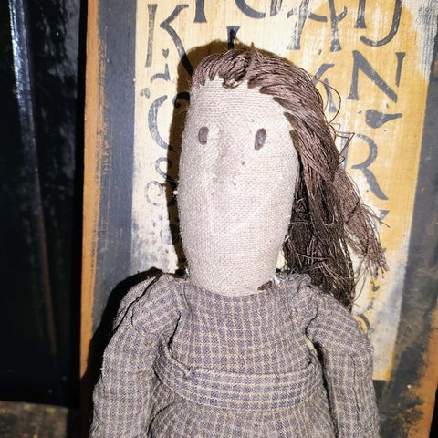 Primitive Doll Holding A Piece Of Fabric That Has ABC,123 Stocked In To It