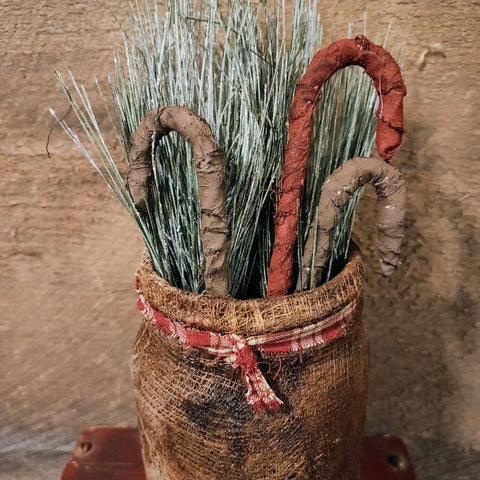 Primitive Jar With fabrics Candy Canes And Greenery