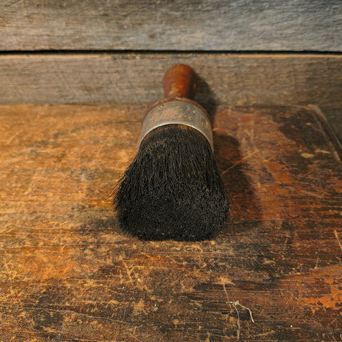 Vintage all-pure bristle round paint brush with a wooden handle.