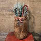 Primitive Jar With fabrics Candy Canes And Greenery