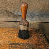 Vintage all-pure bristle round paint brush with a wooden handle.