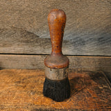Vintage all-pure bristle round paint brush with a wooden handle.
